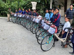 sixteen bikes in a row with their new owners—school girls in Nepal